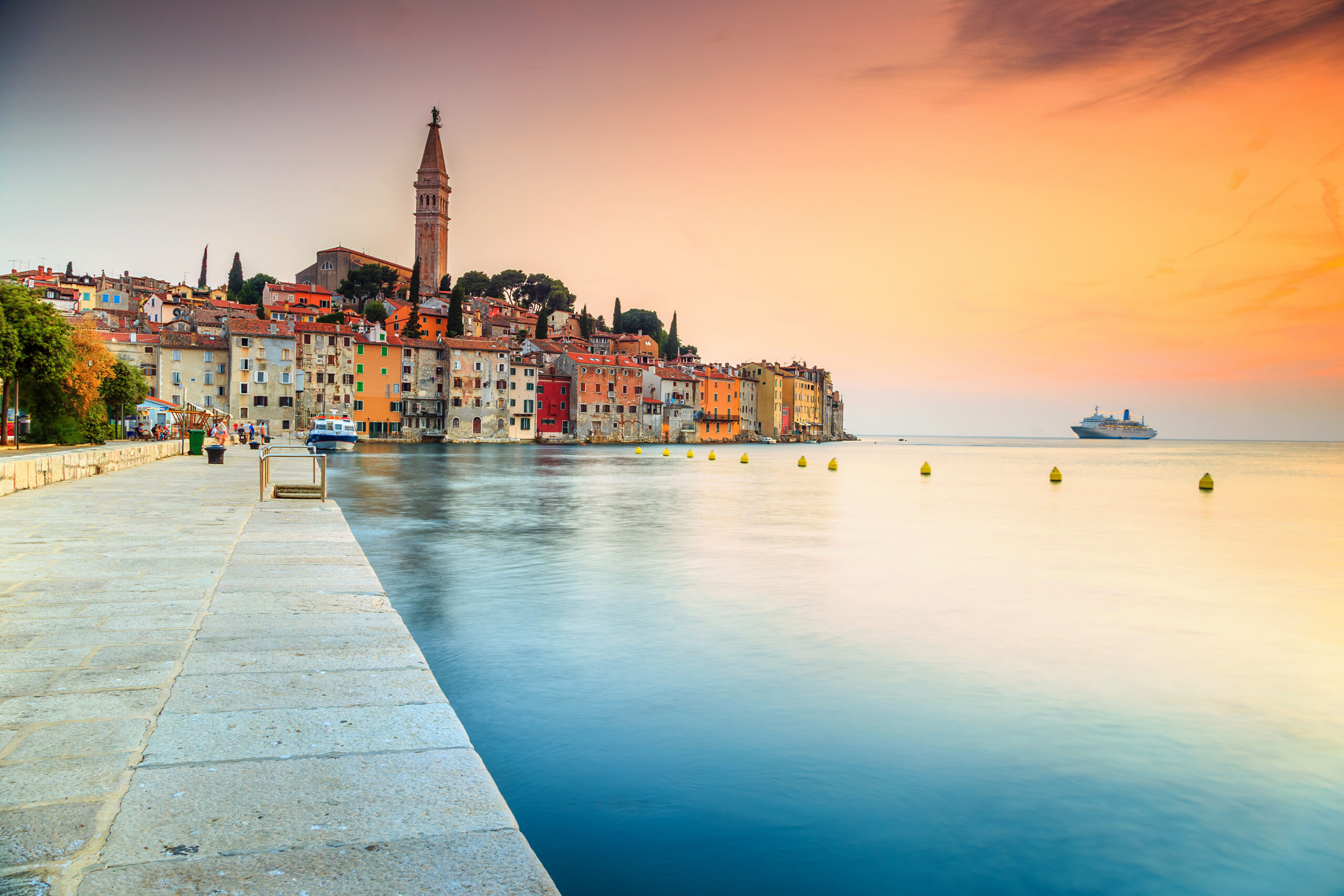 Famous romantic promenade with beautiful old town and magical sunset on peninsula.